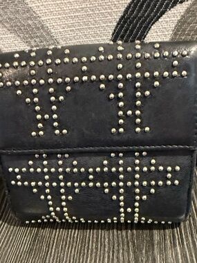 Christian Dior studded black compact wallet.
